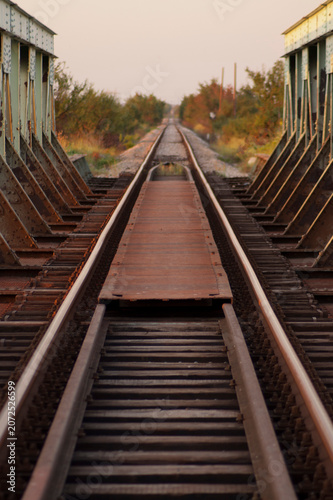 Railway Tracks Crossing Steel Bridge at Sunset