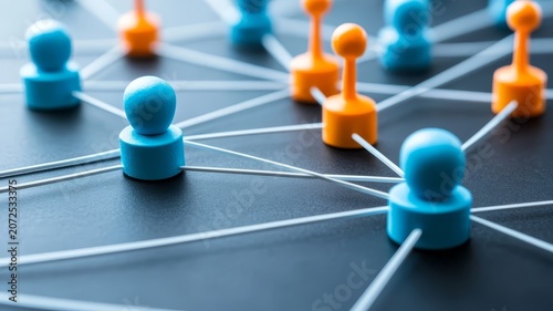 Abstract social network visualization with connected blue and orange figurines on dark background surface conceptual representation