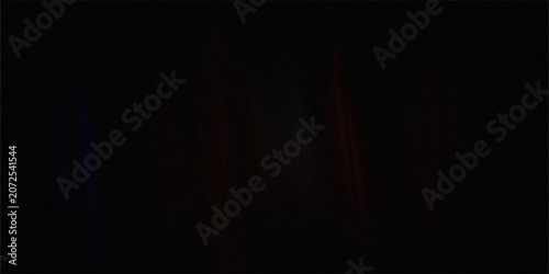 Foto Faint dark abstract background with dim red and blue vertical light highlights emerging from deep black grainy textured space