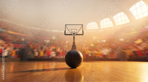 Basketball on court in empty arena with blurred crowd