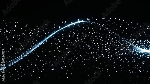 Glowing white particles flowing in a wavy line on a black background