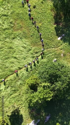 Drone Tracking Shot of a Crowd of Hikers on a Steep Mountain Trail