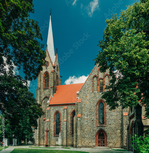 Wide angle of 19th century Catholic Christian stone church, Europe, Poland.