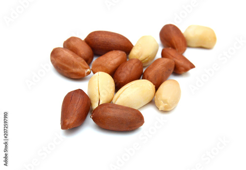Dried peanuts in closeup on white