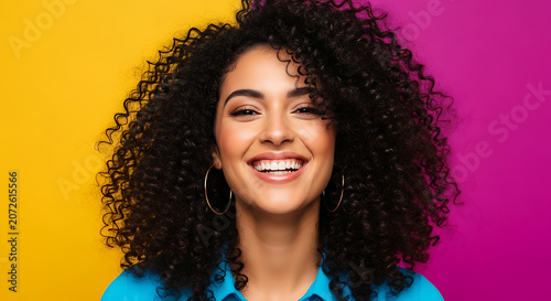 Close up portrait of happy woman with curly black hair