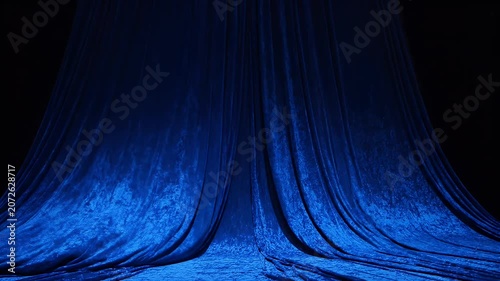 Blue Velvet Fabric Draped Elegantly on a Stage with Soft Lighting.