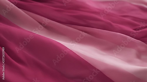 Close-up of flowing magenta and pink fabric, creating a soft, elegant background texture.