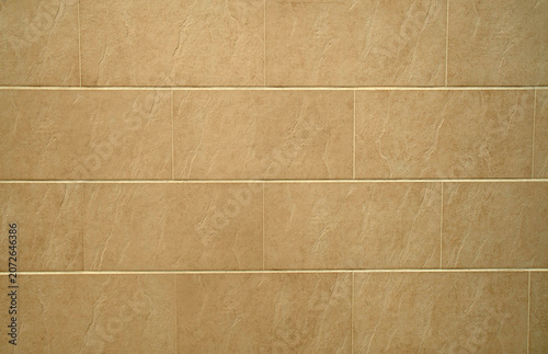 Beige ceramic tile wall texture background, modern exterior cladding pattern