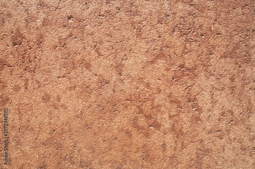 Pink rough limestone rock surface closeup