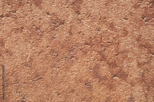Pink rough limestone rock surface closeup