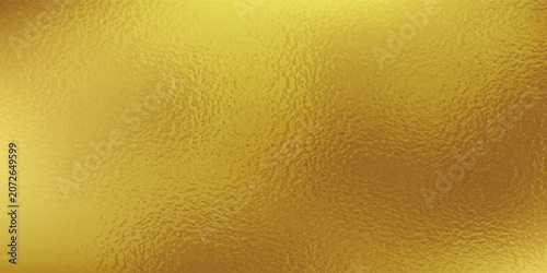 Gold wall texture background. Yellow shiny gold foil paint on wall sheet with gloss light reflection, vibrant golden paper luxury wallpaper