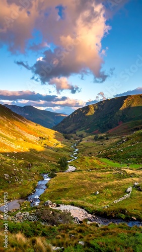 Scenic mountain valley with winding stream at sunset