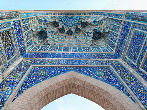 Ornate tilework and muqarnas vault of Gur Emir mausoleum portal in Samarkand, Uzbekistan. Ideal for travel publications, heritage content, and architectural features about Islamic design.