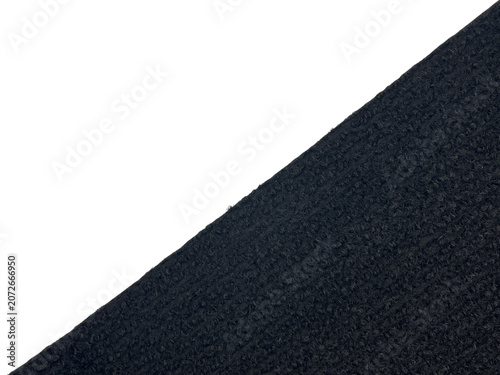 Obraz na płótnie Close-up abstract image showing a textured black surface diagonally dividing the frame against a solid black background