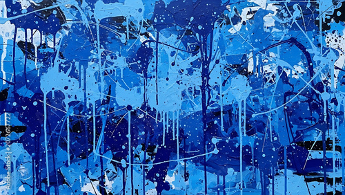 Abstract blue paint splash texture with drips and splatters creating a dynamic artistic background, splatter