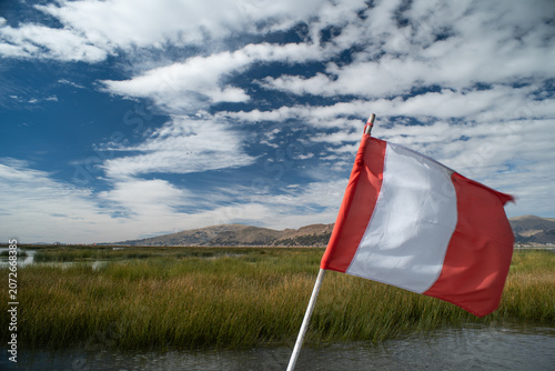 Konstfotografi Peruvian flag on a boat traveling on Lake Titicaca.