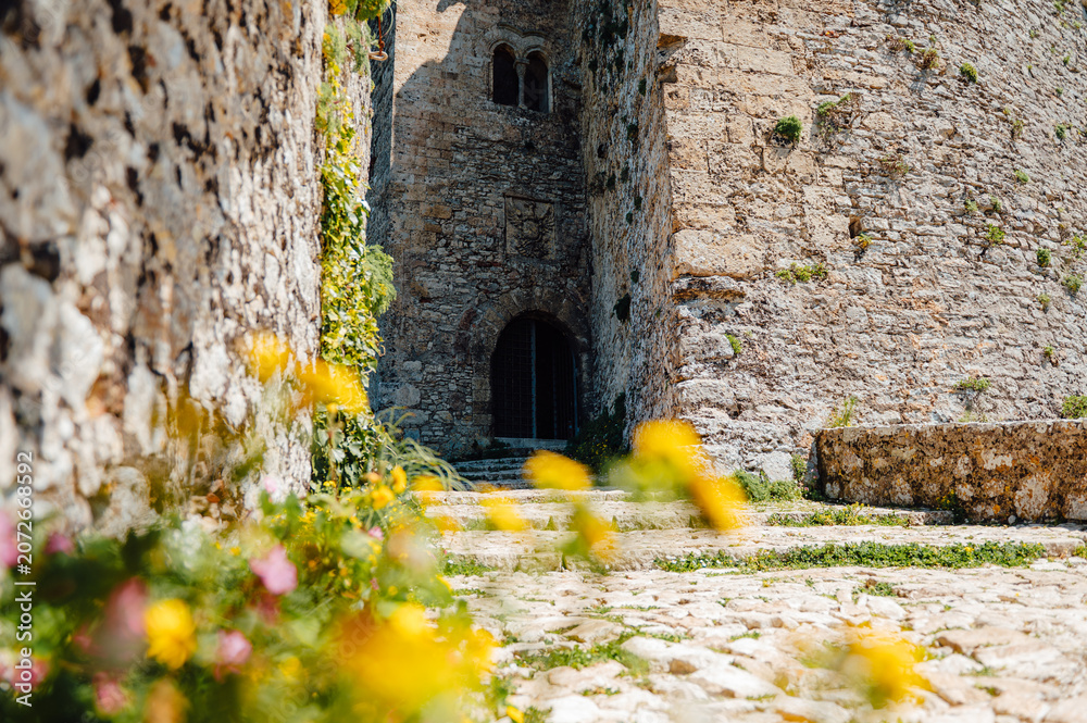 Naklejka premium Flower lined pathway leading to Castello di Venere in Erice, Sicily