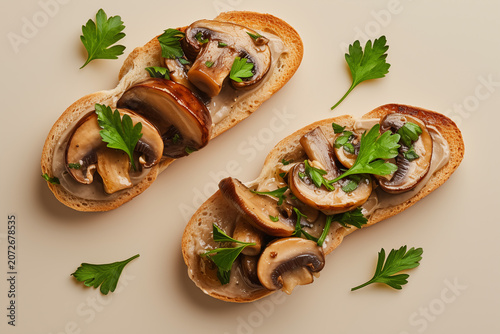 Mushroom bruschetta meticulously layered with creamy spread, roasted mushrooms and fresh parsley leaves in a minimalist textural study