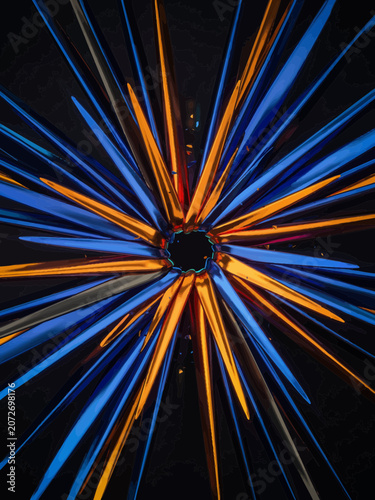 Blue Orange Light Trails Radiating from Center on Black Background