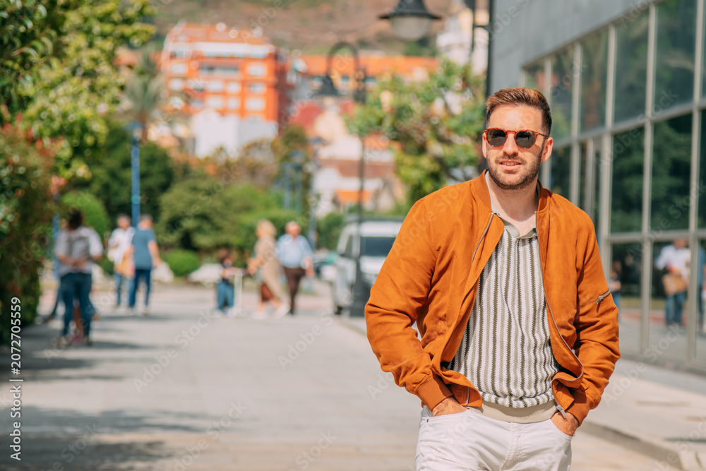 Fototapeta premium Casual man walking through the city