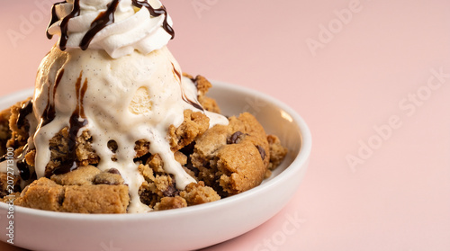 Gourmet Chocolate Chip Cookie Sundae with Vanilla Ice Cream and Chocolate Drizzle on Pink Background