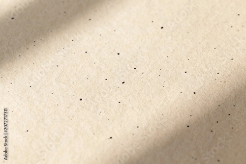 Close-up of textured recycled paper with soft shadows