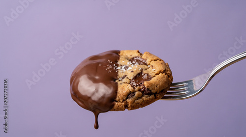 Gourmet Chocolate Dipped Cookie Bite on Fork with Sea Salt on Purple Background