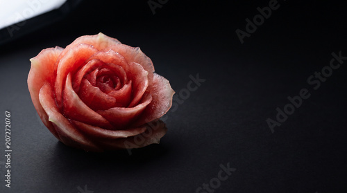 Artistic Watermelon Rose Carving on Dark Slate Background