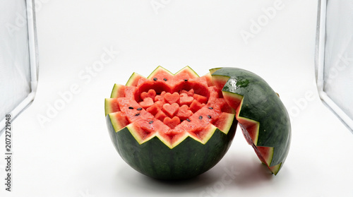 Carved Watermelon with Heart-Shaped Chunks Inside a Light Box