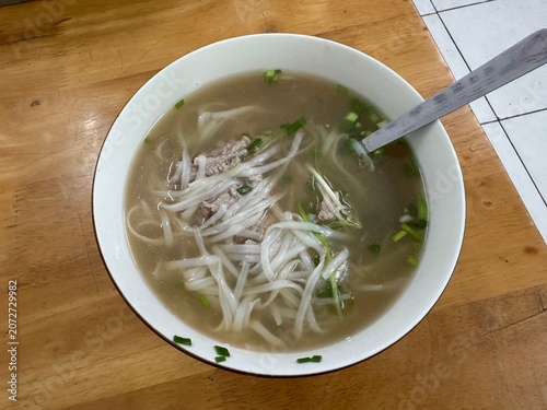 Traditional Vietnamese beef noodle soup pho bo inside a white bowl 