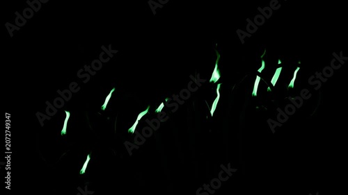 green flames against a stark black background