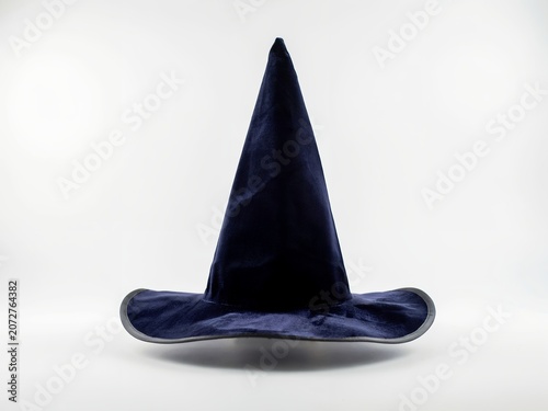 A dark blue velvet witch hat with a wide brim and a pointed isolated on a plain white background, studio lighting, front view