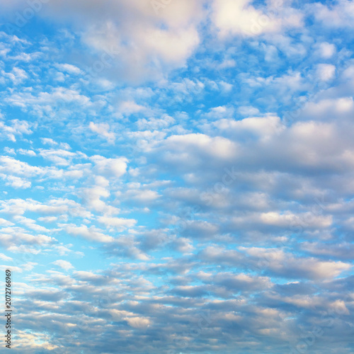 melting clouds filled the blue sky illuminated by sunlight