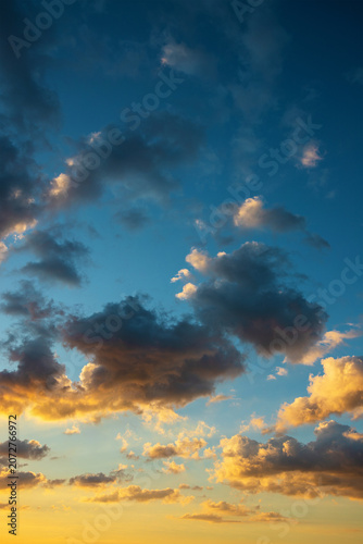colorful clouds in the sky at sunset illuminated by fierce rays of the sun