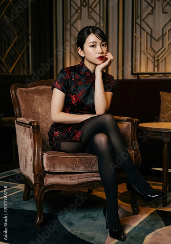 Beautiful Chinese lady posing in Chinese traditional Cheongsam / Qipao.
