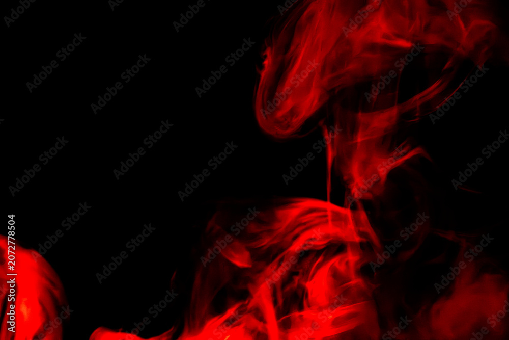 Fototapeta premium Abstract Red Smoke Swirling on Black Background with Glowing Fiery Vapor Effect