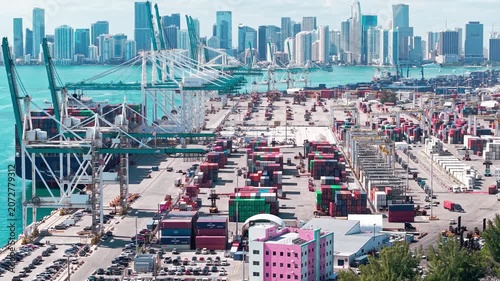 Miami, Florida, USA - April 02, 2025: Freight container of cargo. Port Miami. Container loading. Export and import. Cargo business. 4k footage. Cargo services with container in port, aerial view