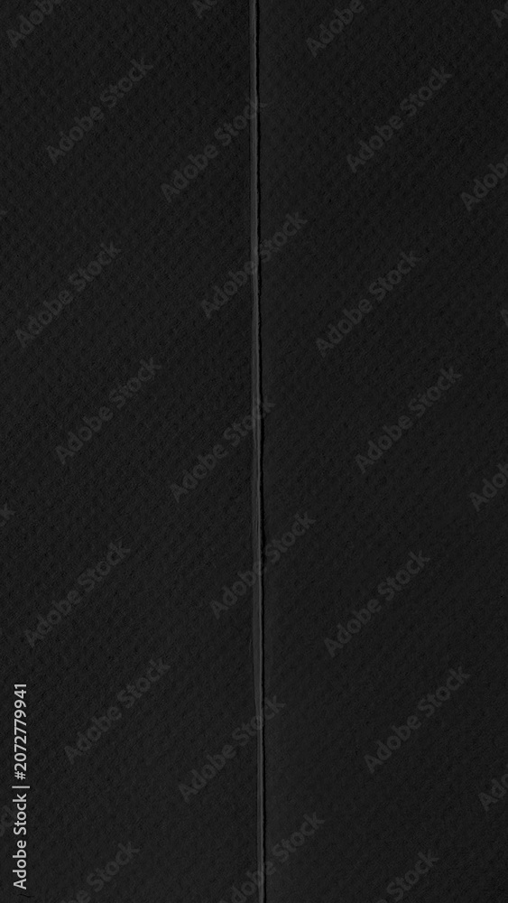 Fototapeta premium Black textured mobile wallpaper with a subtle vertical seam design.