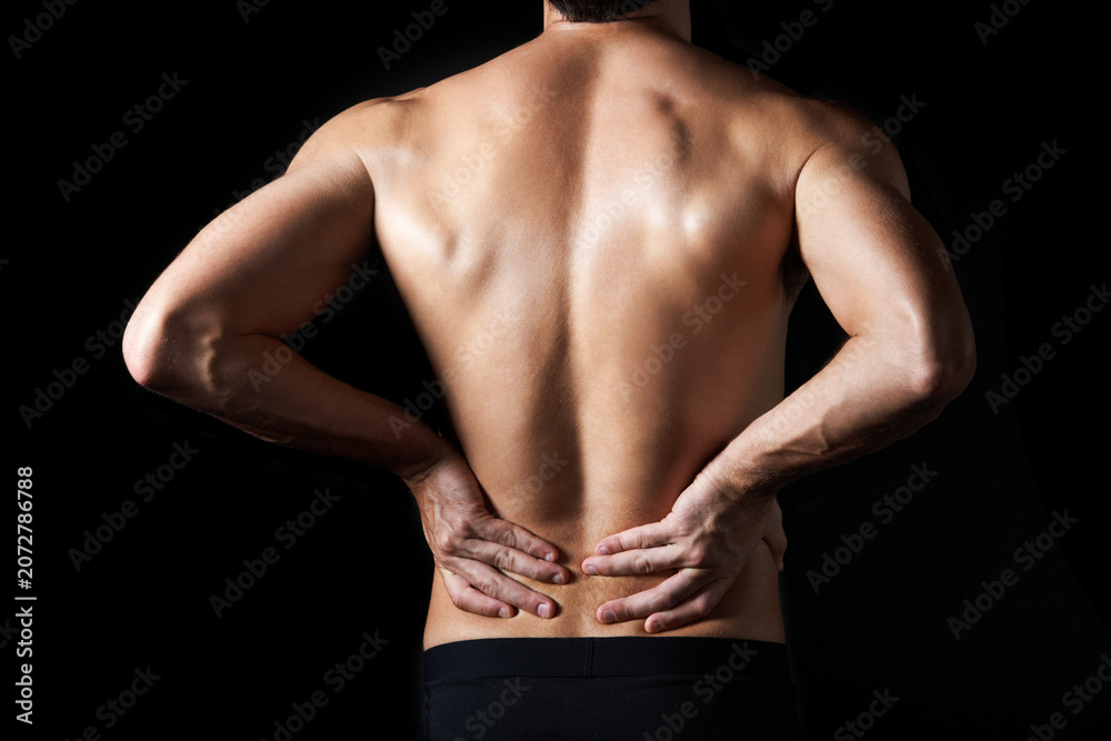 Fototapeta premium Shirtless, body and man in studio for back pain, inflammation or injury with arthritis. Fibromyalgia, sprain and male person by black background with muscle tension, accident or joint ache.
