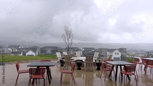 Wet Patio Furniture in Suburban Yard During Storm