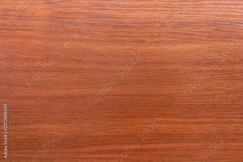 The background is a mahogany texture.Wooden magnolia walnut background.