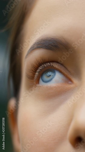 Eye Opens Revealing a Striking Blue Iris Gazing Upward
