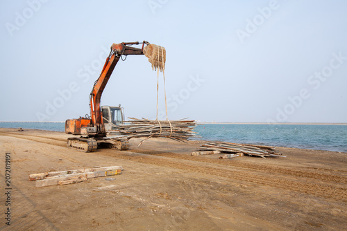 Photography Excavator Being Hoisted during Coastal Construction in Jinshan District, Shangha