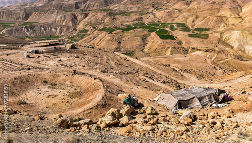 Tableau sur toile Traditional Bedouin tents stand on a rocky hillside in the Dead Sea region of Jordan