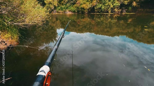 Fishing Rod Over Calm River Surrounded by Green Nature, First Person View, 4K