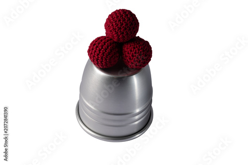 фотографія Magic cups and red balls isolated on white