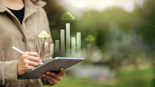 Tableau sur toile Business Professional Analyzing CO2 Emissions Data on Digital Tablet for Carbon