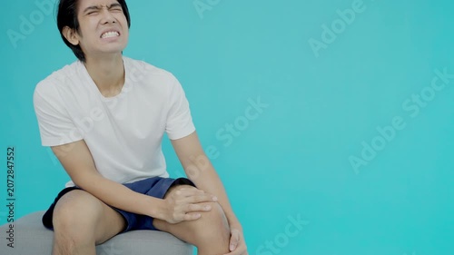 Asia male athlete or spot male having knee injury due to ligament inflammation, man knee pain due to exercise, massage, muscle relaxation, rheumatoid arthritis, gait disturbance, rheumatoid arthritis
