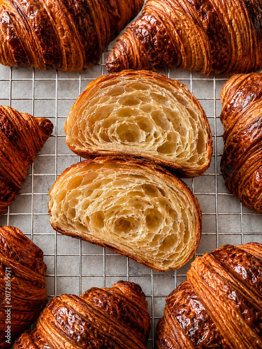 Freshly Baked Croissants with Flaky Cross Section on Cooling Rack