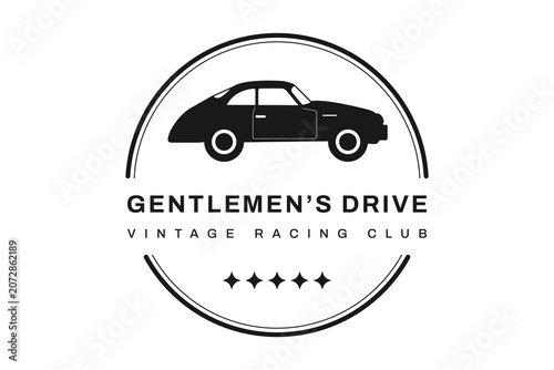 A monochrome logo features a black silhouette of a retro coupe car inside a double circle design.